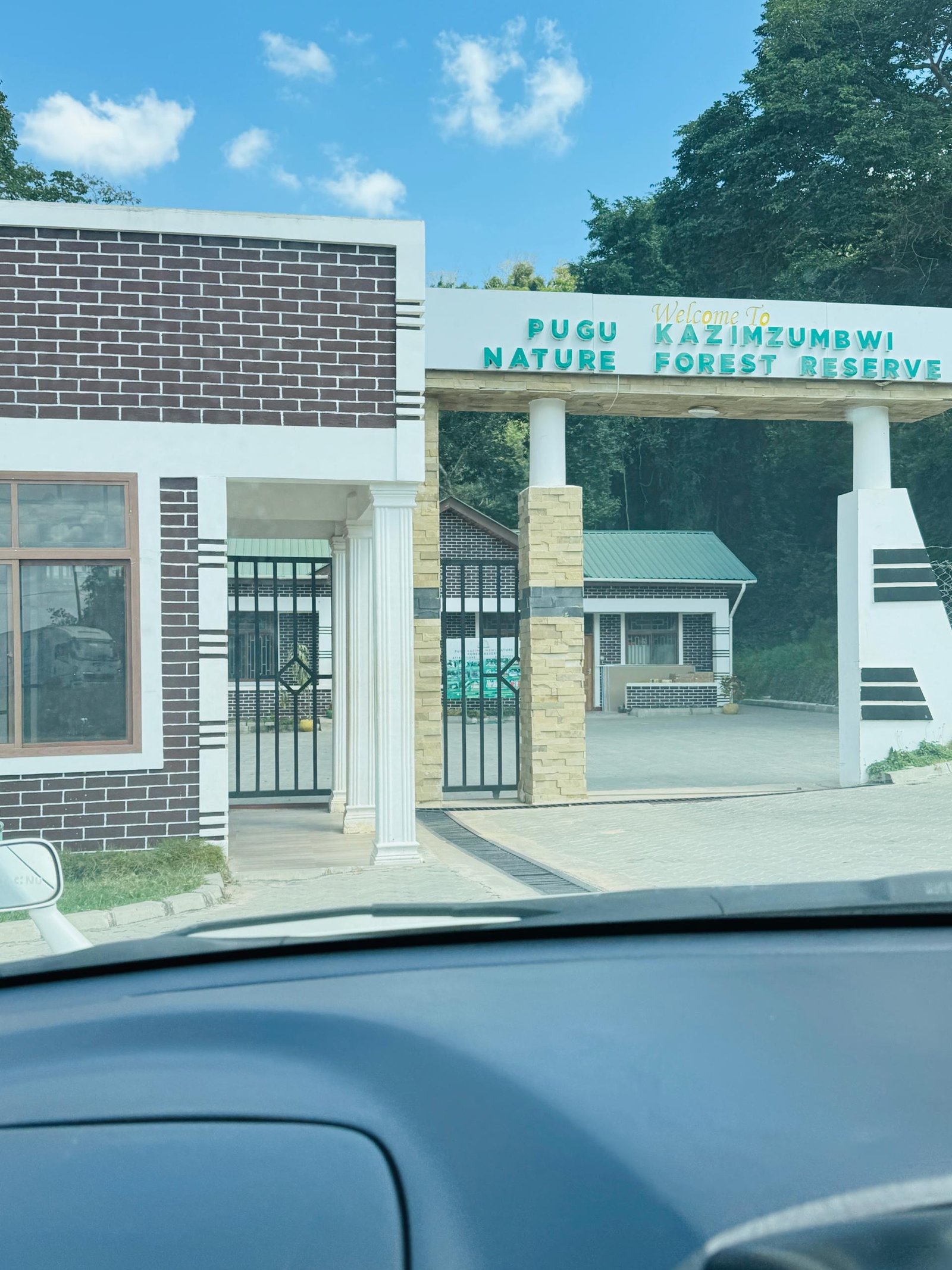 Main entrance gate signage reading 'Welcome to Pugu Kazimzumbwi Nature Forest Reserve'